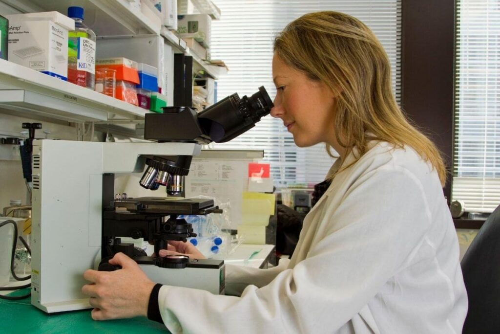 scientist-using-microscope-in-medical-laboratory-training-facility